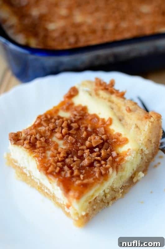 Decadent Creme Brulee Cheesecake Bars 4 Close-up of a single Creme Brulee Cheesecake Bar with a golden-brown top