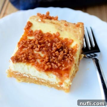 Decadent Creme Brulee Cheesecake Bars 5 Creme brulee cheesecake bar on a white plate next to a fork, showcasing its perfect layers