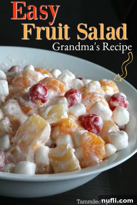 Easy Fruit salad grandma's recipe over a white bowl filled with fruit salad with marshmallows
