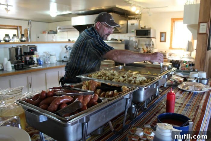 An inviting buffet table laden with an array of delectable dishes including savory meats, roasted potatoes, and fresh vegetables at Bull Hill Guest Ranch's dining hall.