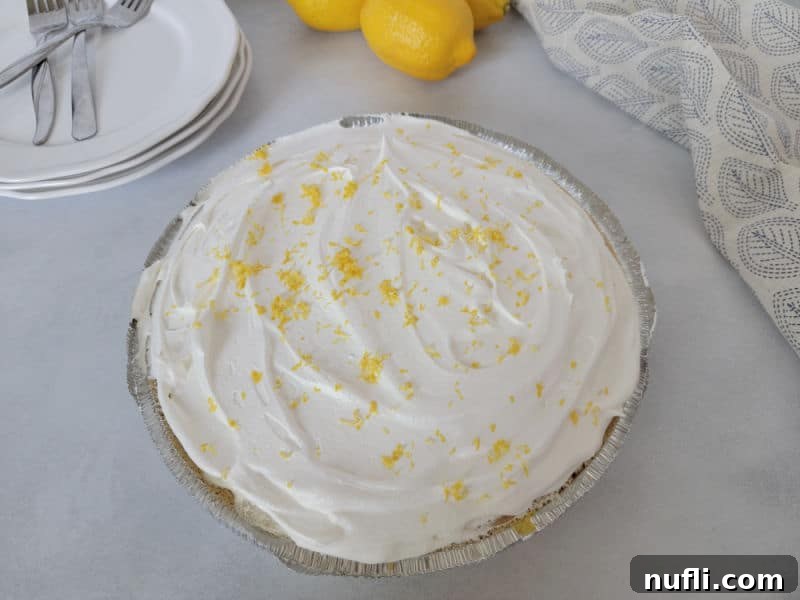 Sunshine Lemon Icebox Pie 8 No bake lemon pie with lemon zest on top of it.