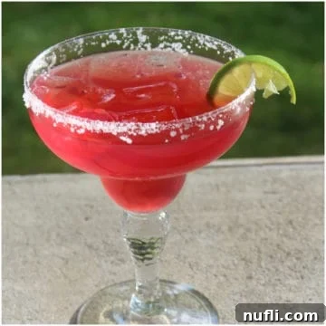 Recreate Chevy's Famous Sunburn Margarita Recipe 3 Red margarita in a margarita glass with salt and a lime wedge