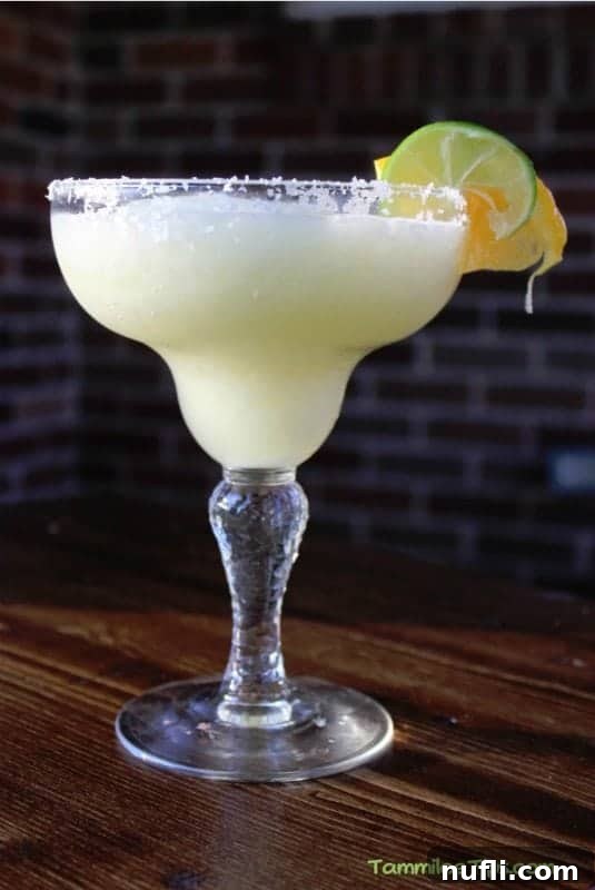 Crisp White Wine Margarita 3 White wine margarita in a classic margarita glass garnished with lime and orange wheel