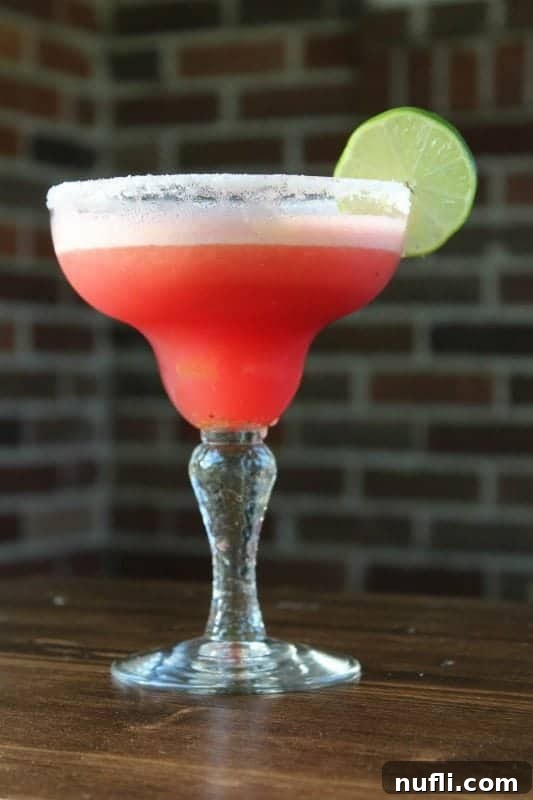 Refreshingly Simple Watermelon Margarita Video 3 watermelon margarita garnished with a lime wheel