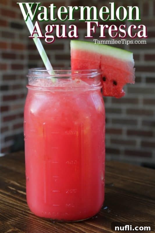 A large mason jar filled with vibrant Watermelon Agua Fresca, garnished with a fresh watermelon slice, ready to refresh on a hot day.