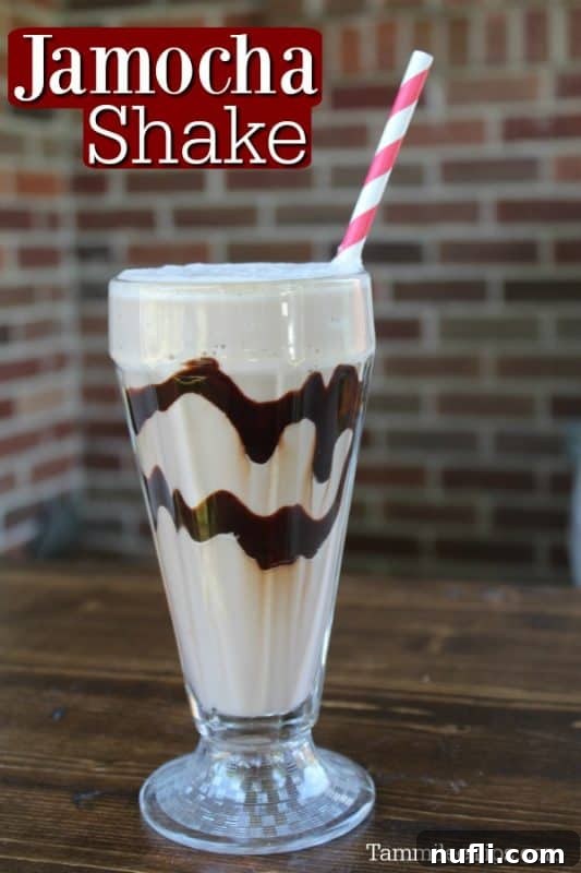 Homemade Jamocha Shake in a tall glass with chocolate swirls and a striped straw, invitingly presented