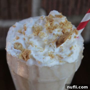 Sonic Coconut Cream Pie Shake in a shake glass garnished with whipped cream and graham cracker crumbs