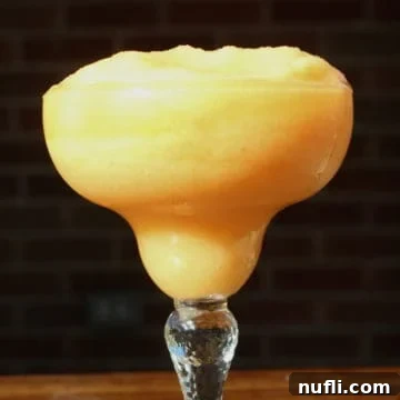 Frozen Peach Daiquiri in a margarita glass
