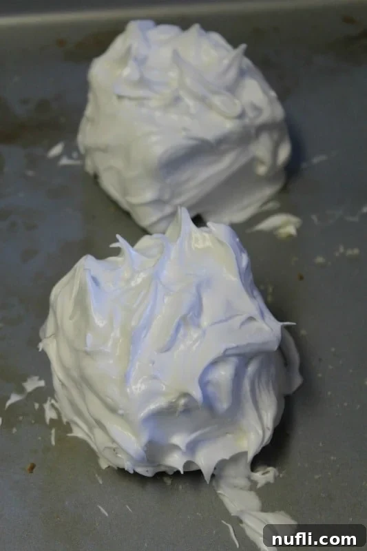 Meringue spread over baked alaska on a baking dish