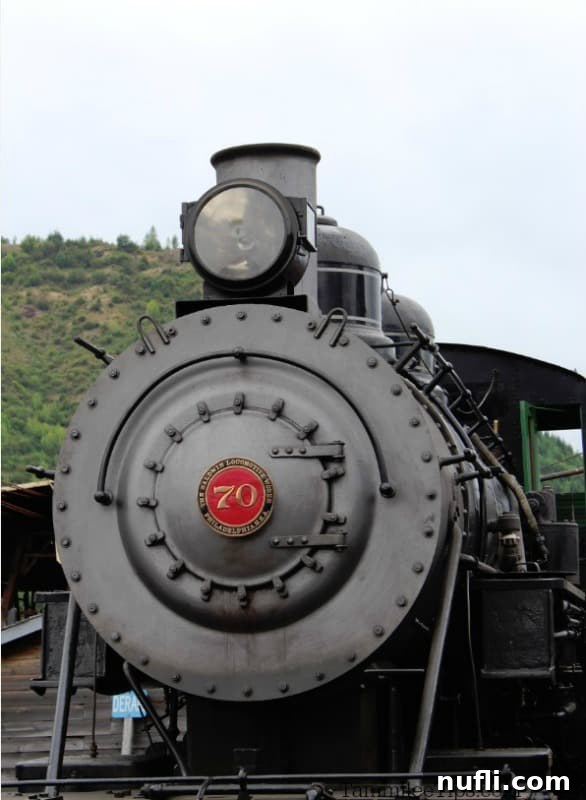 A historic black train engine, number 70, proudly displaying the Mount Rainier Scenic Railroad logo.