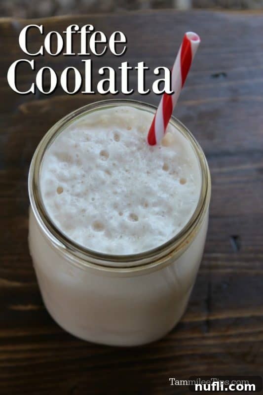 A refreshing homemade Dunkin Donuts Coffee Coolatta served in a mason jar with a striped straw, perfect for summer.