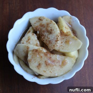 Homemade Boston Market Apples 4 Boston Market Apples in a white bowl, showcasing their golden-brown color and soft texture.