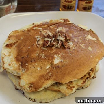 Classic Southern Pecan Pancakes 5 Stack of copycat Cracker Barrel Pecan Pancakes on a white plate