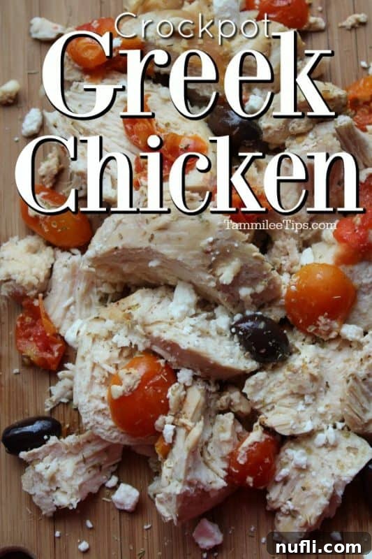 Crockpot Greek Chicken over a wood platter with chicken, tomatoes, and Kalamata olives, ready to serve.
