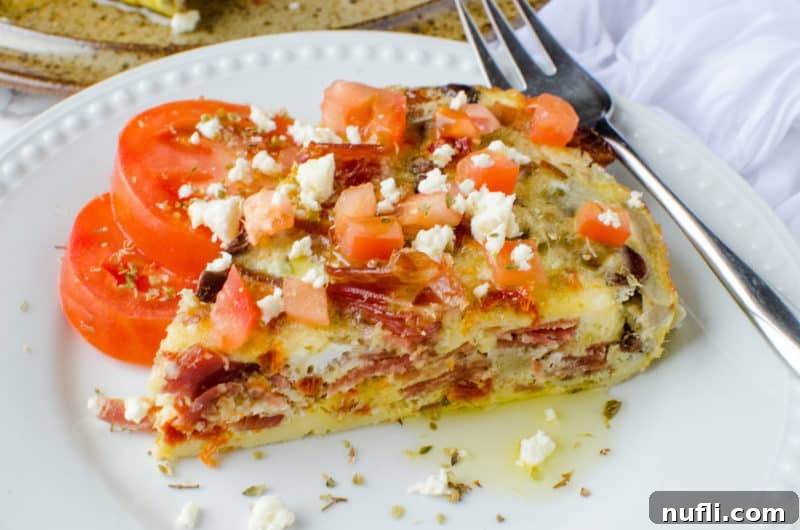 Greek frittata on a white plate with a fork