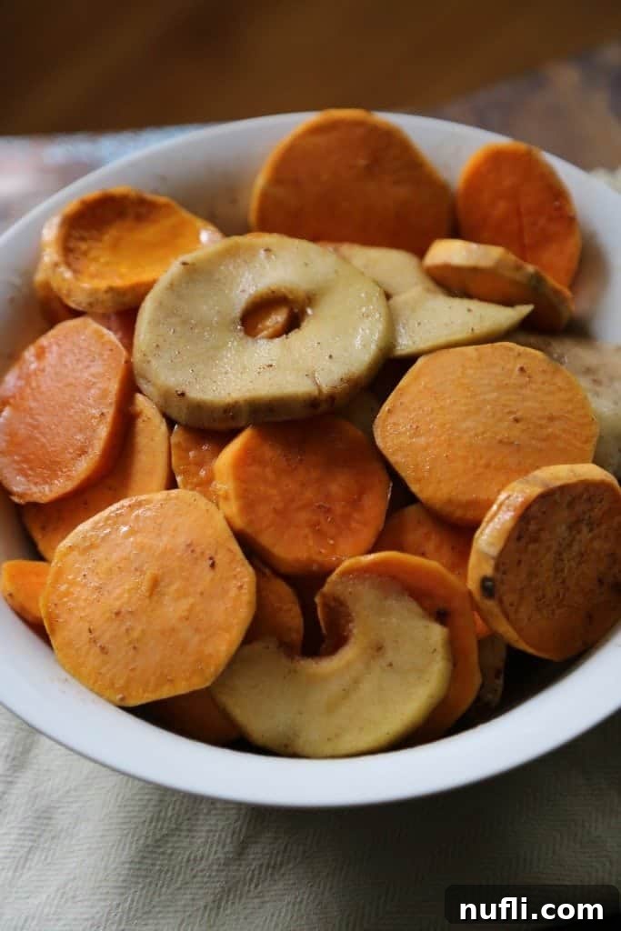 Crock Pot Apples and sweet potatoes slices in a white bowl