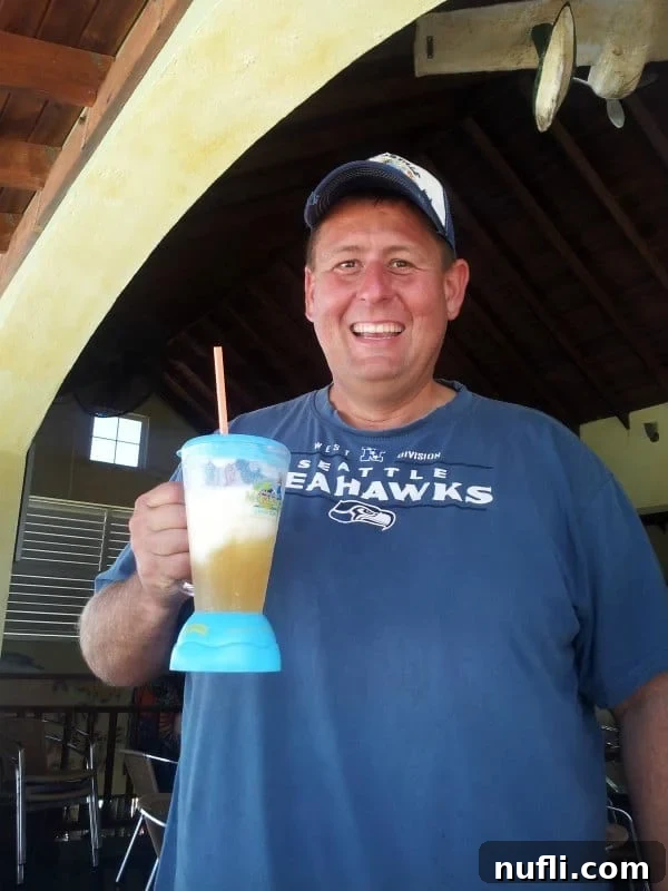 John holding a margaritaville mug