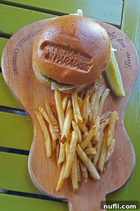 Guitar shaped board with a cheeseburger in paradise and french fries