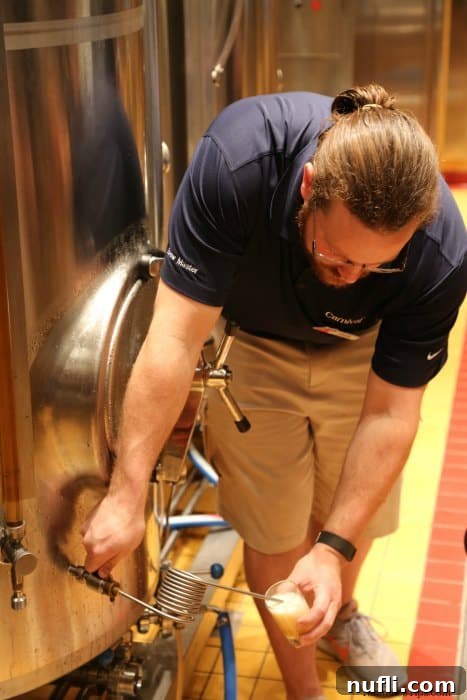 Carnival employee pouring beer from a large cask