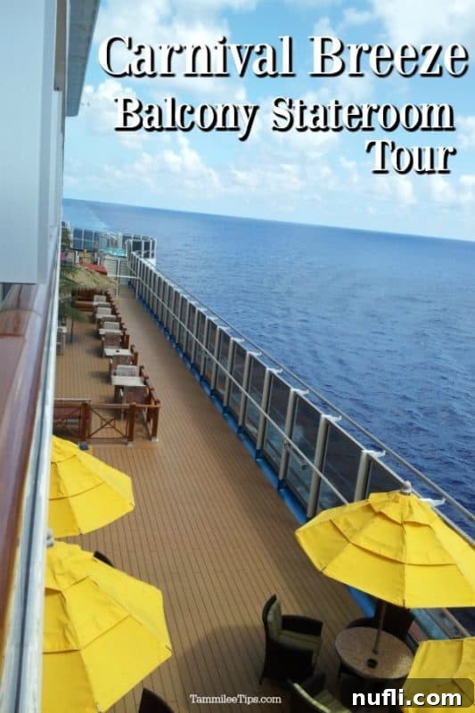 Carnival Breeze Balcony Stateroom overlooking the side deck of the cruise ship, showing a glimpse of the ocean
