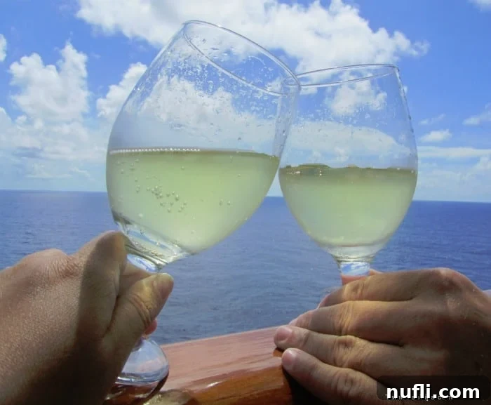 Hands holding champagne glasses together, celebrating a special moment on a cruise ship balcony