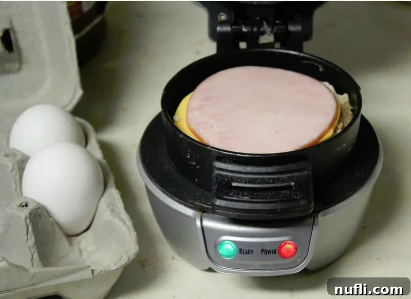 The Ultimate Homemade Breakfast Muffin 3 A carton of fresh eggs sits beside the Hamilton Beach Breakfast Sandwich Maker, ready to create a delicious ham and cheese breakfast