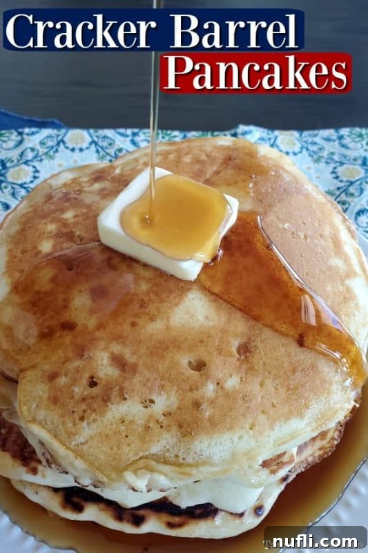 Homemade Cracker Barrel Buttermilk Pancakes 2 Cracker barrel pancakes over a plate of pancakes with butter and syrup pouring over the pancakes