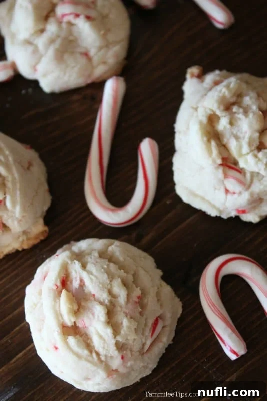 White chocolate candy cane cookies on a cutting board with candy canes