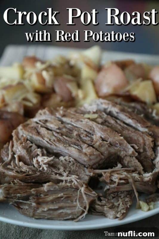 Alaskan Amber Slow Cooker Roast 2 Hearty slow cooker pot roast with red potatoes, onions, and carrots, infused with Alaskan Amber beer, served on a rustic platter.