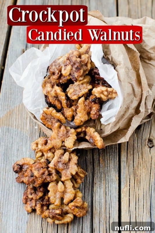 Sugared walnuts spilling out of a paper bag onto a rustic wooden table.