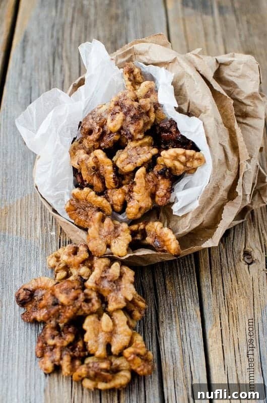 Sugared walnuts in a paper bag, ready for gifting or snacking.