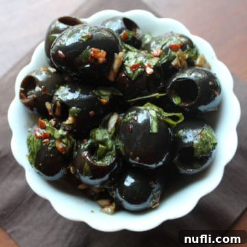 marinated olives in a white bowl