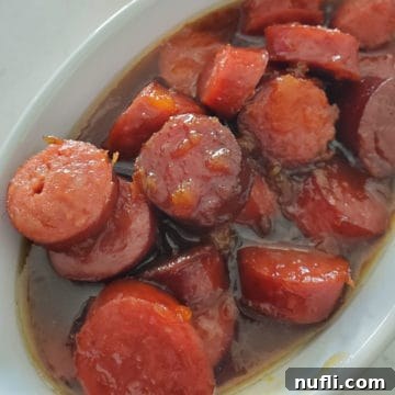 bourbon glazed kielbasa in a white bowl