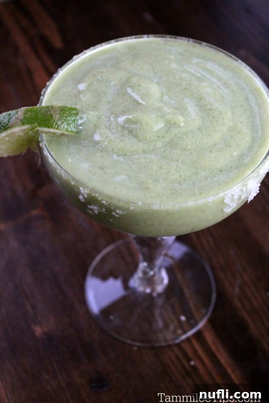 Crafting the Perfect Avocado Margarita 3 Avocado Margarita in a traditional margarita glass, garnished with a fresh lime wedge.