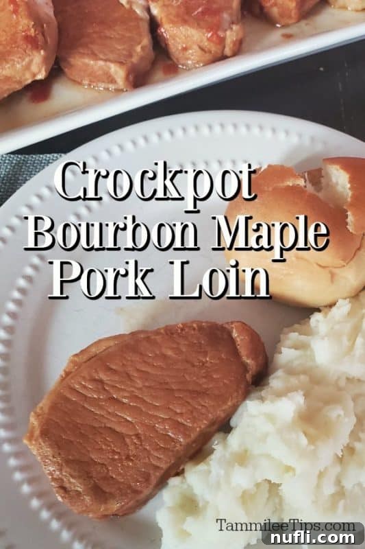 Flavorful crockpot bourbon maple pork loin served on a white plate with a side of fluffy roll, creamy mashed potatoes, and vibrant green vegetables.