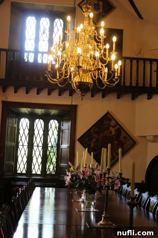 Malahide Castle and Gardens, Dublin, Ireland 4 Chandelier over a long dining table with flowers and candles inside Malahide Castle