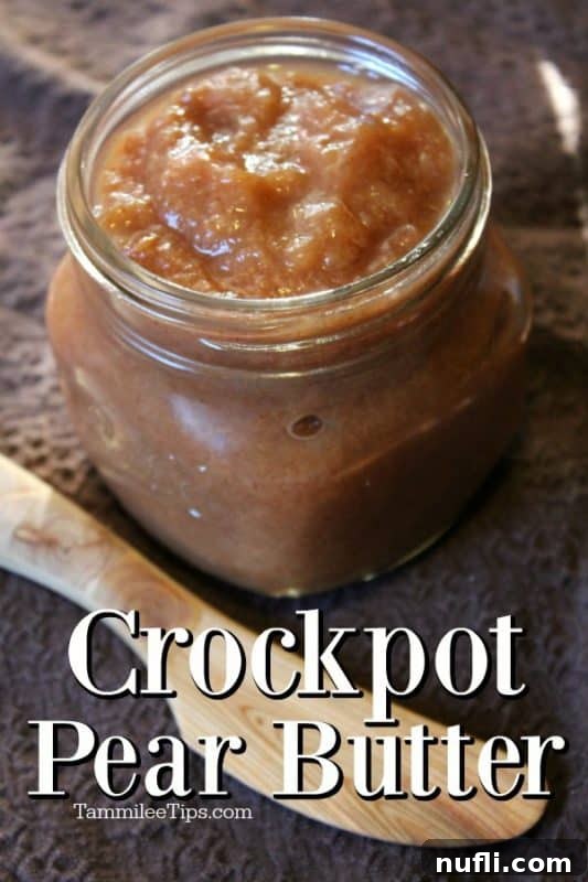 Crockpot pear butter in a glass mason jar on a brown napkin with a wooden knife