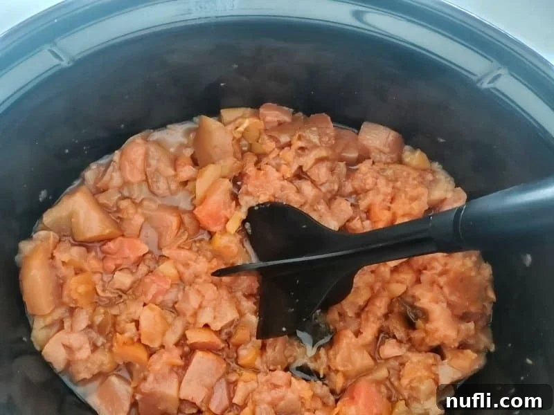 pears being mashed in a crockpot bowl