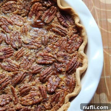 Pumpkin Pecan Pie in a white pie dish