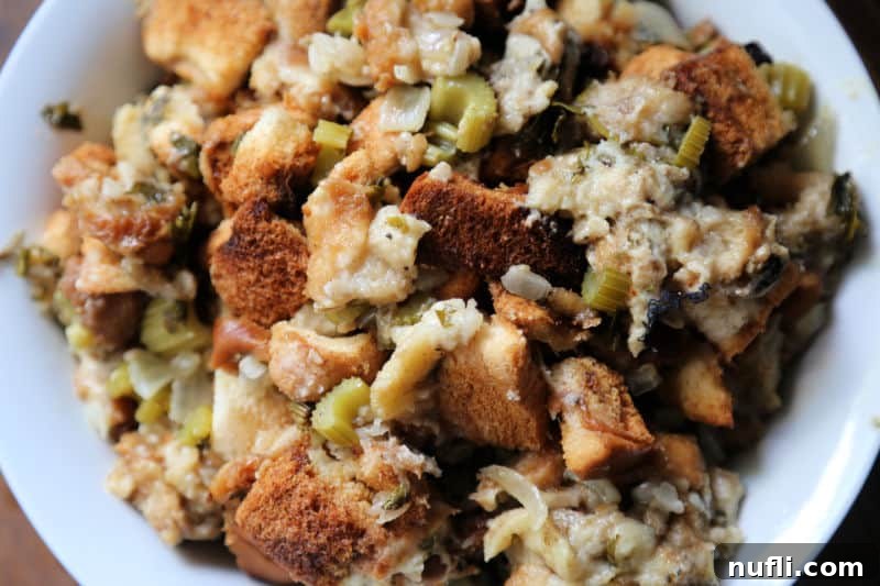 Slow cooker stuffing in a white bowl with bread and celery