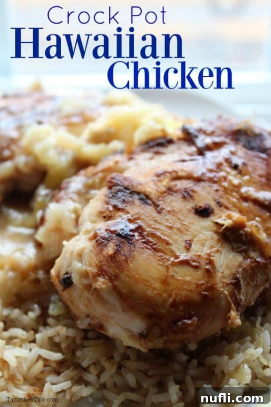 Crockpot Hawaiian Chicken served over rice with pineapple chunks on a white plate, garnished with fresh cilantro.