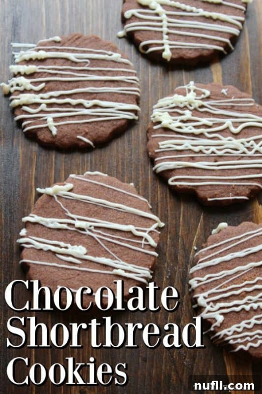 Rich chocolate shortbread cookies with a delicate white chocolate drizzle, artfully arranged on a rustic wooden board, ready to be enjoyed.