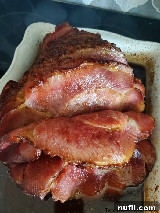 Spiral sliced bourbon ham in a baking dish, glazed and ready to eat