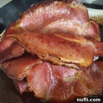 sliced bourbon honey ham in a baking dish