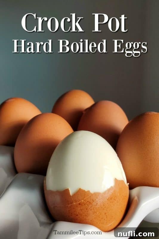 Slow Cooker Perfect Hard Boiled Eggs 2 Crockpot hard boiled eggs over eggs in a white egg carrier with one of them partially peeled.