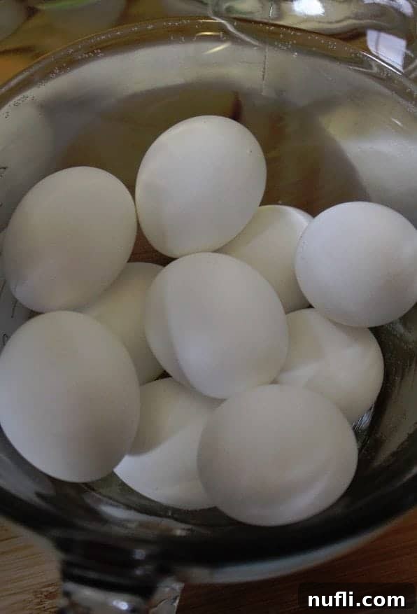 Effortless Hard-Boiled Eggs in Your Slow Cooker 4 Cooked hard-boiled eggs cooling in a bowl of ice water, a crucial step for easy peeling.