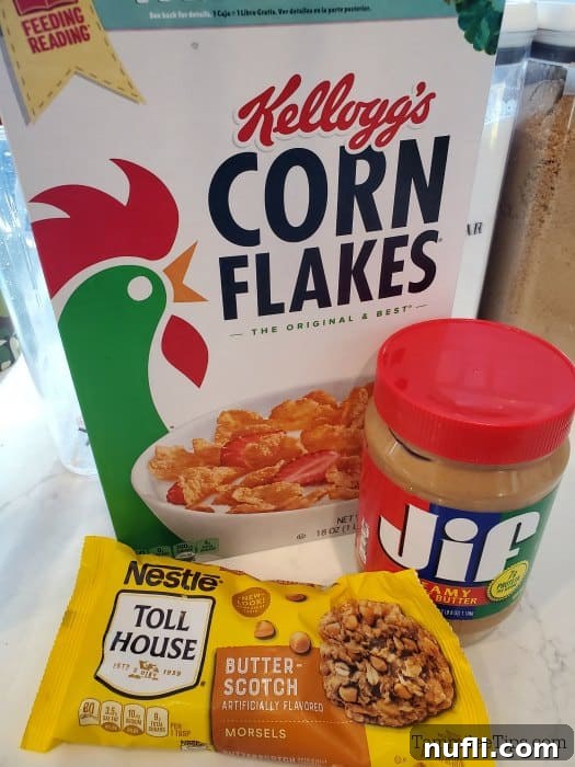 Three core ingredients for no-bake butterscotch cornflake cookies: corn flakes, creamy peanut butter, and butterscotch chips, neatly displayed.