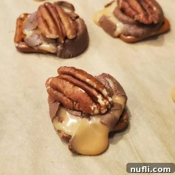 3 Ingredient Rolo Pretzel Turtles on parchment paper