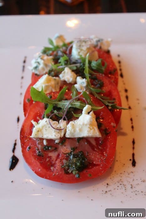 Fresh Caprese salad elegantly presented on a white platter