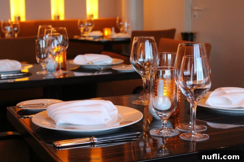 Elegant tables set with Fahrenheit 555 branding, crisp plates, and wine glasses